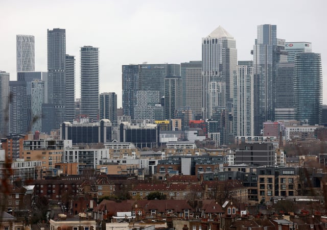 A view of the Canary Wharf financial district and residential houses in London, Britain, January 23, 2025. REUTERS/Hannah McKay/File Photo