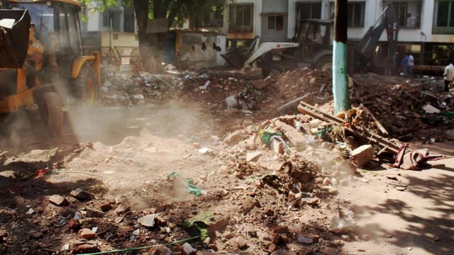 A bulldozer demolishing an allegedly illegal dargah in Nashik district of Maharashtra on Wednesday. (PTI Photo)