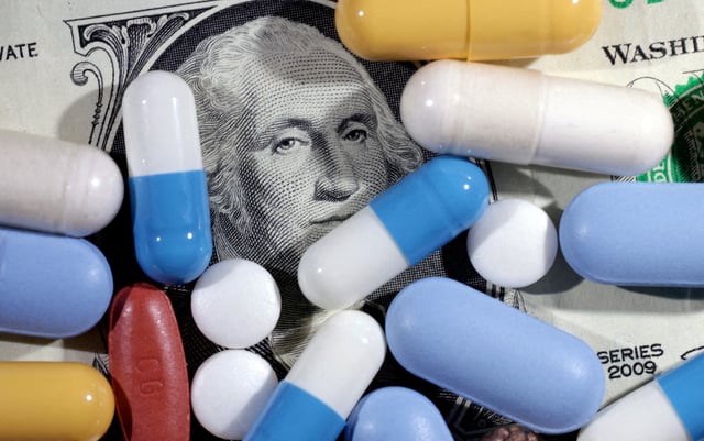 U.S. dollar banknote and medicines are seen in this illustration taken, June 27, 2024. REUTERS/Dado Ruvic/Illustration//File Photo