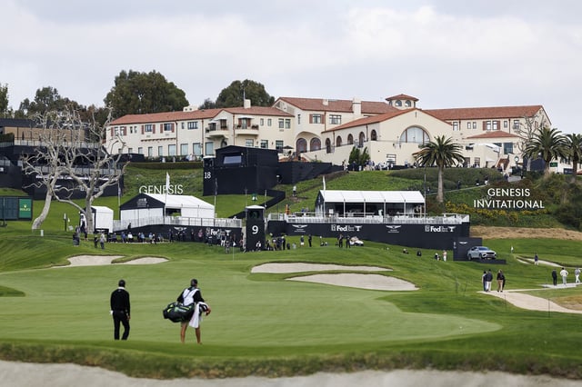 The Riviera Country Club clubhouse is seen from the ninth hole as Tiger Woods and caddie Lance Bennett walk the fairway during the Genesis Invitational pro-am golf event at Riviera Country Club, Wednesday, Feb. 14, 2024, in the Pacific Palisades area of Los Angeles. (AP Photo/Ryan Kang)