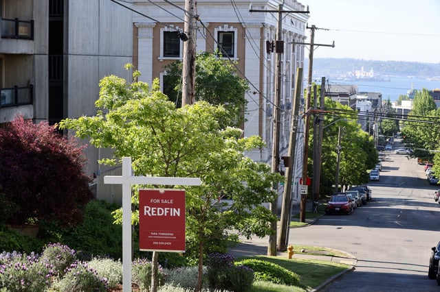A "For Sale" sign is posted outside a residential home in the Queen Anne neighborhood of Seattle, Washington, U.S. May 14, 2021.   REUTERS/Karen Ducey/File Photo