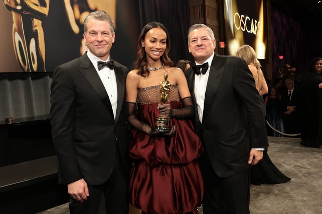 Netflix co-CEOs Greg Peters and Ted Sarandos with Zoe Saldaña at the Oscars