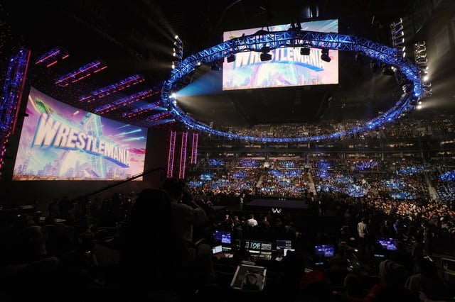FILE - A WrestleMania sign hangs over the crowd during a WWE event, Monday, March 6, 2023, in Boston. (AP Photo/Charles Krupa, File)