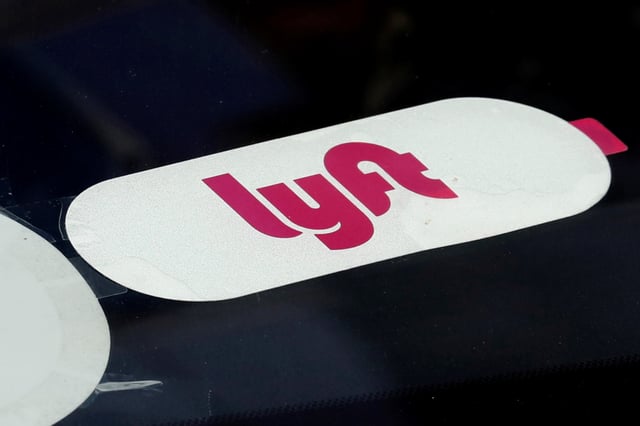 The Lyft logo is seen on ride-hailing car in Manhattan in New York City, New York, U.S., March 4, 2019. REUTERS/Mike Segar/ File Photo