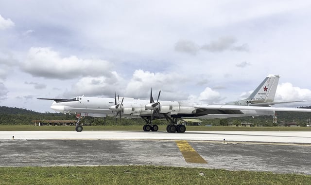 In this photo released by the Russian Defense Ministry on December 5, 2017, a Russian Tu-95 bomber arrives on Biak Island in Indonesia.