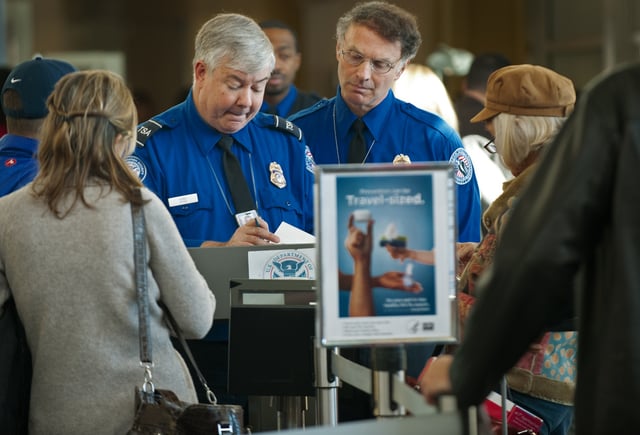 TSA Officers review air traveler&#39;s boarding passes and identification at a security checkpoint inside Ronald Reagan Washington National Airport December 27, 2009, in Arlington, VA, near Washington, DC.