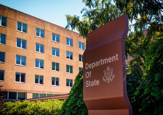 State Department building with sign in the foreground