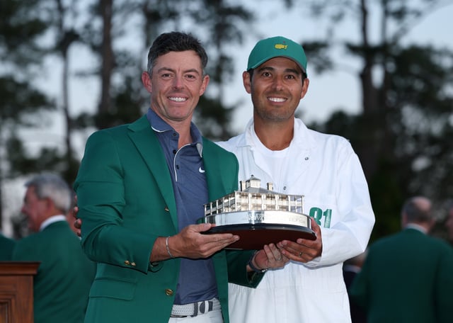 Rory McIlroy of Northern Ireland celebrates with caddie Harry Diamond and the Masters trophy during the Green Jacket Ceremony after winning the 2025 Masters Tournament at Augusta National Golf Club on April 13, 2025 in Augusta, Georgia.