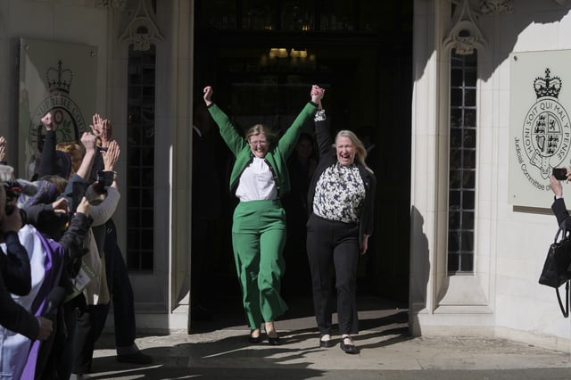 Marion Calder and Susan Smith from For Women Scotland, celebrate outside the Supreme Court to challenge gender recognition laws, in London, Wednesday, April 16, 2025. For Women Scotland is challenging the Scottish Government over whether trans women can be regarded as female for the purposes of the 2010 Equality Act. (AP Photo/Kin Cheung)