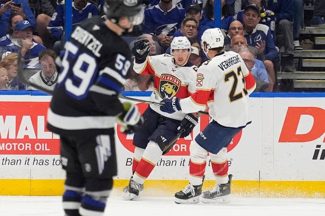 Florida Panthers center Brad Marchand (63) celebrates his goal against the Tampa Bay Lightning with center Carter Verhaeghe (23) during the second period of an NHL hockey game Tuesday, April 15, 2025, in Tampa, Fla. (AP Photo/Chris O&#39;Meara)
