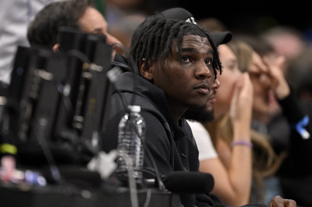 Feb 12, 2025; Dallas, Texas, USA; Miami Hurricanes Quarterback Cam Ward watches the game between the Dallas Mavericks and the Golden State Warriors during the second half at the American Airlines Center. Mandatory Credit: Jerome Miron-Imagn Images/File photo