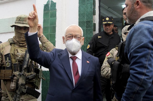 FILE - Leader of Tunisia's Islamist Ennahda party House Speaker Rached Ghannouchi, center, flashes a victory sign as he arrives for questioning at the judicial police headquarters in Tunis, Tunisia, April 1, 2022. (AP Photo/Hassene Dridi, File)