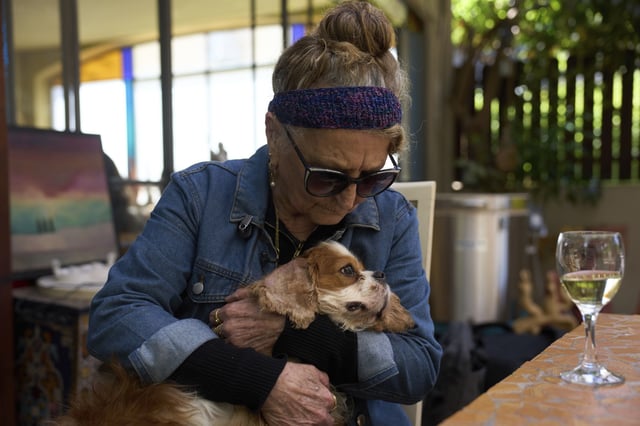 Rachel Dancyg holds her dog, Billie, on Wednesday, April 16, 2025. Israeli soldiers found Billie in the Gaza Strip, 18 months after she disappeared during Hamas' attack on Dancyg's Kibbutz of Nir Oz, in Binyamina, Israel. (AP Photo/Ariel Schalit)