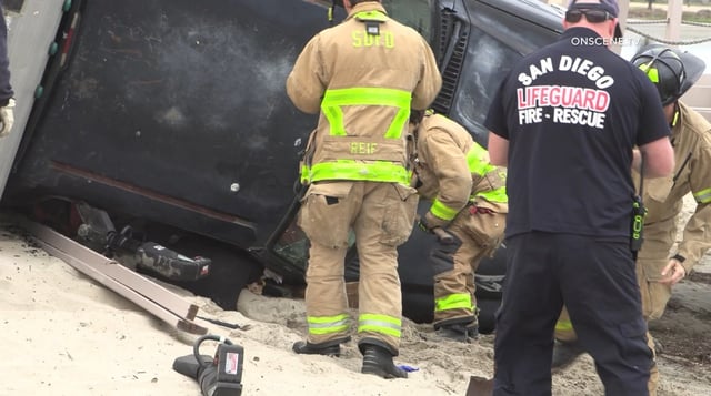 Firefighters rescued a man who was trapped inside his overturned camper truck on the sand near Mission Bay early Wednesday. (OnSceneTV)