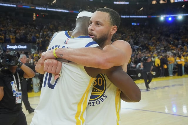 Golden State Warriors forward Jimmy Butler III, left, celebrates with guard Stephen Curry after an NBA play-in tournament game against the Memphis Grizzlies in San Francisco on April 15, 2025.