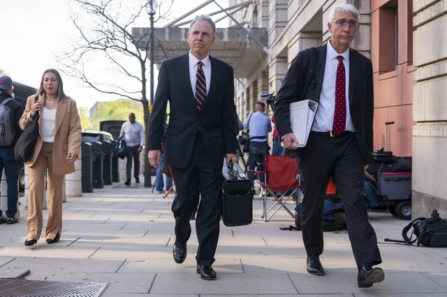Mark Hansen, center, a lawyer for Meta, departs following the first day of a historic antitrust trial about Meta CEO Mark Zuckerberg intentions in acquiring Instagram, at Barrett Prettyman United States Court House in Washington, Monday, April 14, 2025. (AP Photo/Nathan Howard)