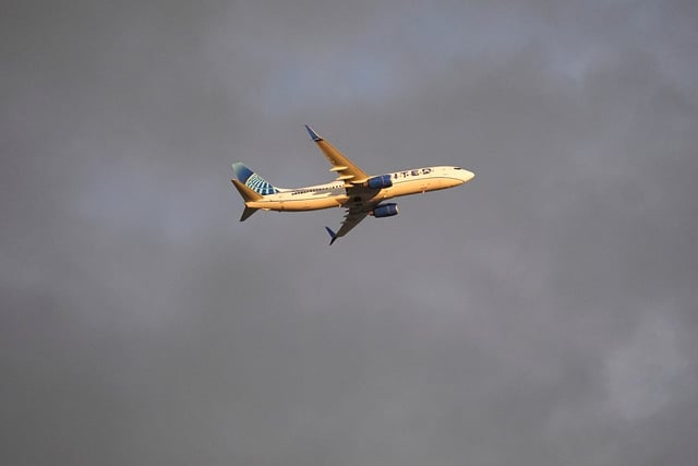 The setting sun colors a United Airlines plane as it takes off against a leaden sky as a summer storm sweeps near Denver International Airport late Tuesday, Aug. 13, 2024, in Commerce City, Colo. (AP Photo/David Zalubowski)