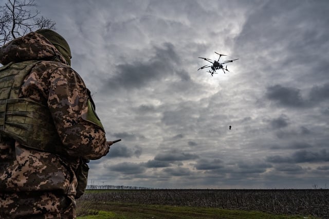 A Ukrainian drone operator who gave the name Artem pilots an attack drone, as commander Andrii looks on (left), as Ukrainian soldiers of the 108th Territorial Defense Brigade test fly a Ukrainian-made Vampire drone near the southern frontline on February 21, 2024 in an unspecified area of Ukraine&#39;s southern Zaporizhzhia region.
