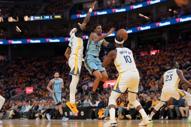 Apr 15, 2025; San Francisco, California, USA; Memphis Grizzlies guard Ja Morant (12) drives to the hoop between Golden State Warriors guard Gary Payton II (0) and forward Jimmy Butler III (10) in the second quarter at the Chase Center. Mandatory Credit: Cary Edmondson-Imagn Images