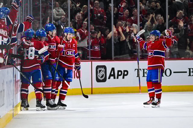 Apr 16, 2025; Montreal, Quebec, CAN; Montreal Canadiens defenseman Kaiden Guhle (21) celebrates with his teammates his second goal of the game against the Carolina Hurricanes in the second period at Bell Centre. Mandatory Credit: David Kirouac-Imagn Images