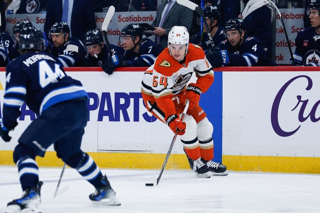 Apr 16, 2025; Winnipeg, Manitoba, CAN;  Anaheim Ducks forward Sam Colangelo (64) skates in on Winnipeg Jets defenseman Josh Morrissey (44) during the first period at Canada Life Centre. Mandatory Credit: Terrence Lee-Imagn Images