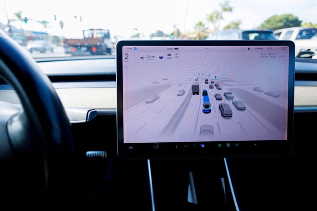 A Tesla Model 3 vehicle drives using FSD (Full Self-Driving) in Encinitas, California, U.S., October 18, 2023.     REUTERS/Mike Blake/File Photo
