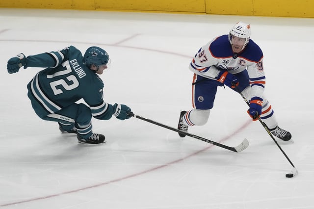 Edmonton Oilers center Connor McDavid (97) skates with the puck against San Jose Sharks left wing William Eklund (72) during the third period of an NHL hockey game in San Jose, Calif., Wednesday, April 16, 2025. 
