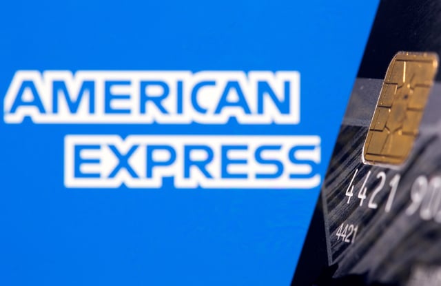Credit card is seen in front of displayed American Express logo in this illustration taken, July 15, 2021. REUTERS/Dado Ruvic/Illustration/File Photo