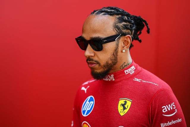 Lewis Hamilton of Great Britain and Scuderia Ferrari looks on in the Paddock during previews ahead of the F1 Grand Prix of Australia at Albert Park Grand Prix Circuit on March 13, 2025 in Melbourne, Australia.