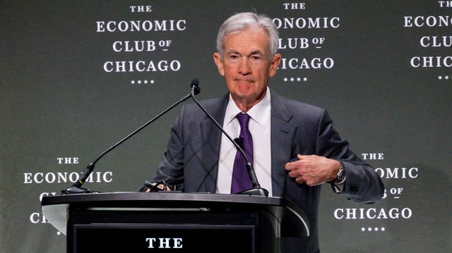 Fed Chair Jerome Powell stands at a lectern during an Economic Club of Chicago event.