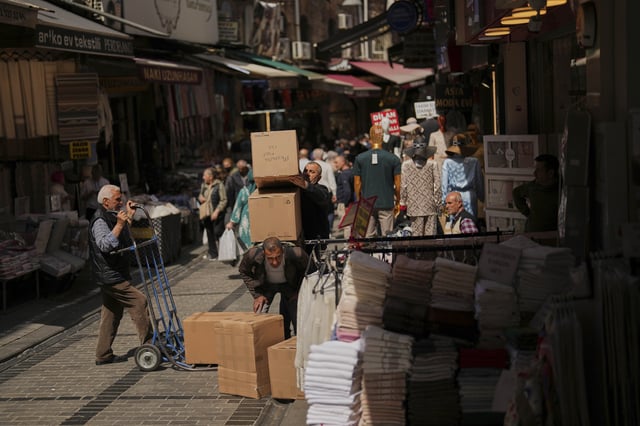 Workers deliver goods to a shop at Eminonu commercial district in Istanbul, Turkey, Thursday, April 17, 2025. (AP Photo/Francisco Seco)