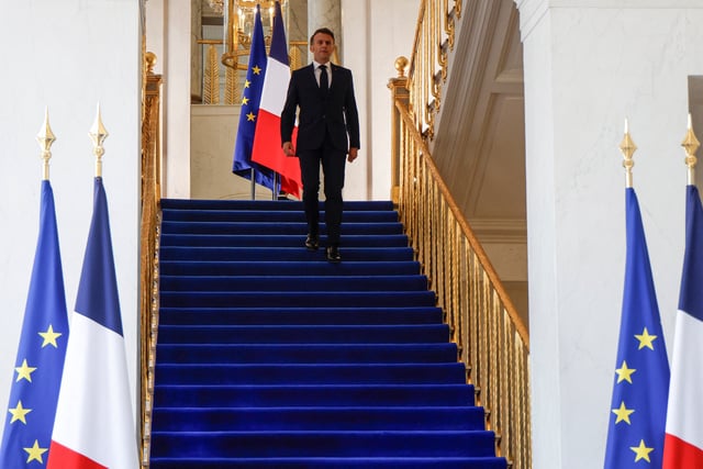 France's President Emmanuel Macron comes down the stairs to welcome US Secretary of State, US Special Envoy and France's Minister for Europe and Foreign Affairs before a meeting at the Elysee presidential palace in Paris on April 17, 2025.  LUDOVIC MARIN/Pool via REUTERS