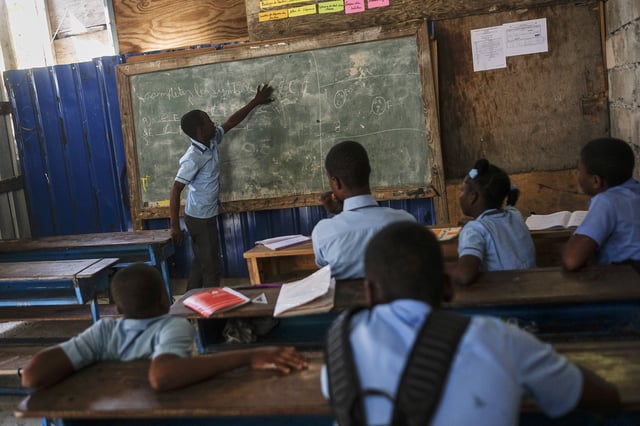 FILE - Students attend a French writing class at the Wesleyenne Regard Divin co-ed primary and middle school in Port-au-Prince, Haiti, Thursday, Oct. 28, 2021. (AP Photo/Matias Delacroix, File
