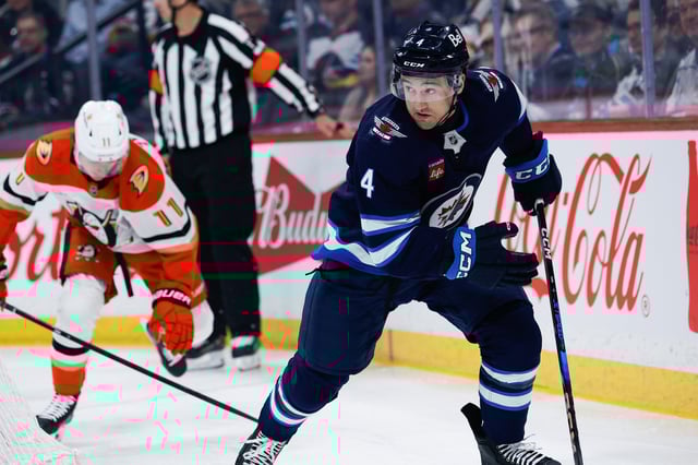 Apr 16, 2025; Winnipeg, Manitoba, CAN;  Winnipeg Jets defenseman Neal Pionk (4) skates away from Anaheim Ducks forward Trevor Zegras (11) during the first period at Canada Life Centre. Mandatory Credit: Terrence Lee-Imagn Images/File photo
