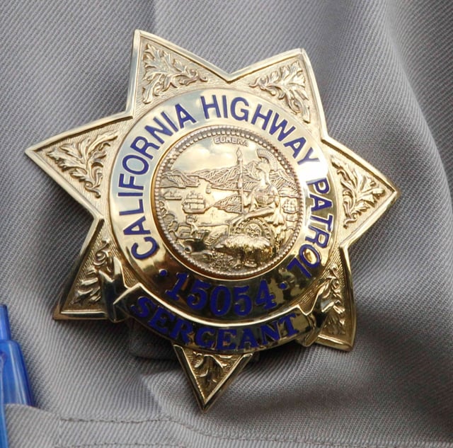 Iconic photo of CHP badge  JOHN GIBBINS / San Diego Union-Tribune)