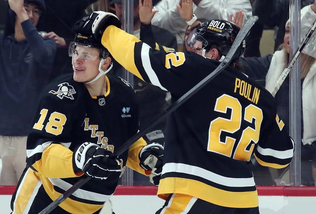 Nov 19, 2024; Pittsburgh, Pennsylvania, USA; Pittsburgh Penguins right wing Sam Poulin (22) congratulates right wing Jesse Puljujarvi (18) on his goal against the Tampa Bay Lightning during the first period at PPG Paints Arena. Mandatory Credit: Charles LeClaire-Imagn Images/File photo