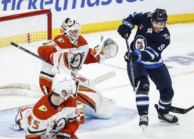 Winnipeg Jets' Alex Iafallo (9) tips the puck towards Anaheim Ducks goaltender Ville Husso (33) during third period NHL action in Winnipeg on Wednesday, April 16, 2025. THE CANADIAN PRESS/John Woods
