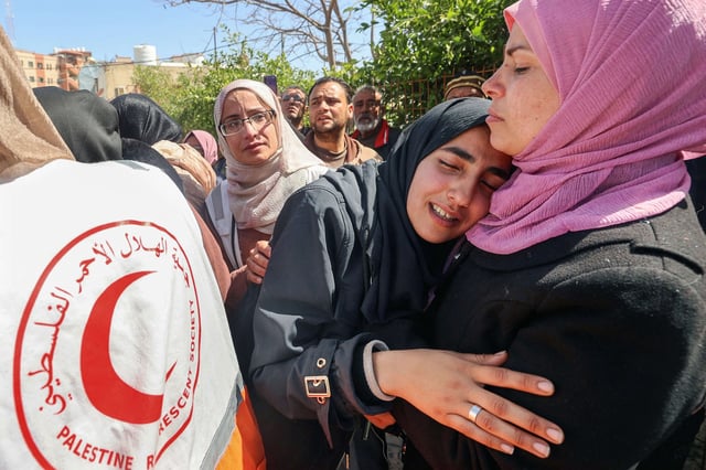 Relatives mourn during the funeral procession for members of the Palestine Red Crescent and other emergency services who were killed a week earlier by Israeli forces, at Nasser hospital in Khan Yunis in the southern Gaza Strip on March 31, 2025.