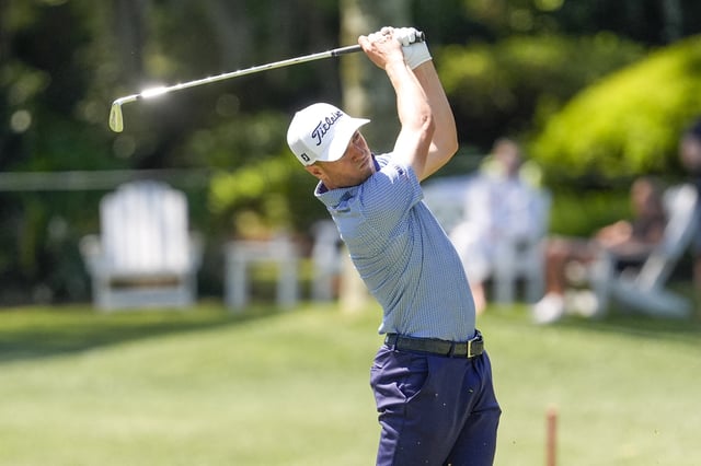 Apr 17, 2025; Hilton Head, South Carolina, USA; Justin Thomas hits his approach shot to eight green during the first round of the RBC Heritage golf tournament. Mandatory Credit: Jim Dedmon-Imagn Images