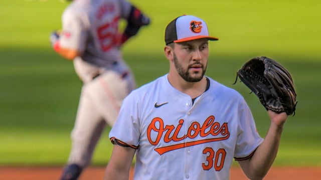 Baltimore Orioles starting pitcher Grayson Rodriguez awaits a new ball after yielding a solo home run to Boston Red Sox batter Wilyer Abreu who rounds the bases during an AL-East division game of Major League baseball at Oriole Park at Camden Yards. (Karl Merton Ferron/Staff)