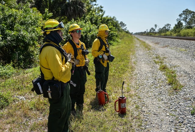 The Florida Park Service along with AmeriCorps conduct a controlled burn, also known as a prescribed burn, within Jonathan Dickinson State Park in on Friday, March 14, 2025, in Hobe Sound.
