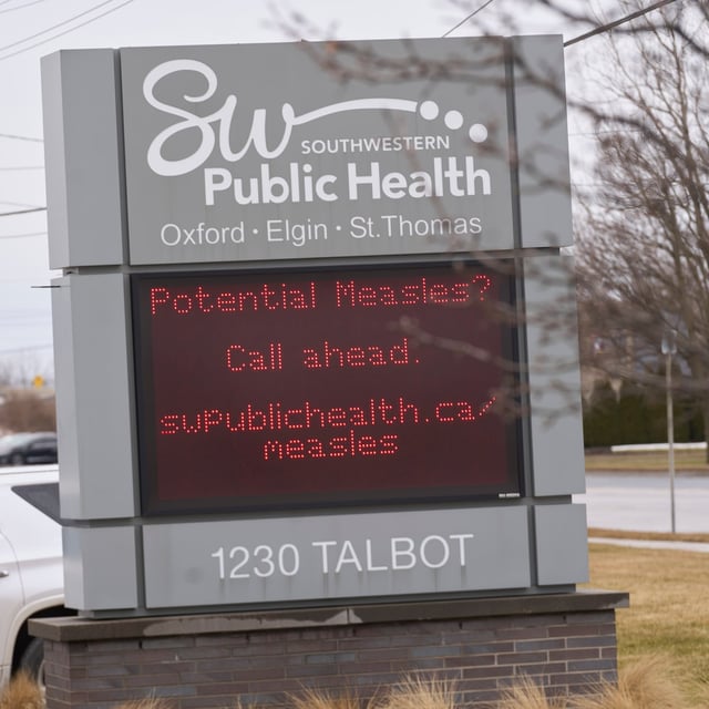 A sign outside Southwestern Public Health in St. Thomas, Ont. on Tuesday, March 4, 2025 warns residents to call ahead before visiting a doctor or hospital if they think they have the measles. THE CANADIAN PRESS/ Geoff Robins