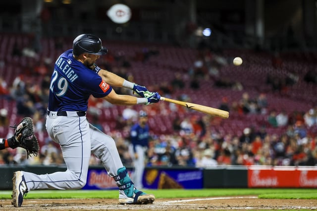 Apr 16, 2025; Cincinnati, Ohio, USA; Seattle Mariners catcher Cal Raleigh (29) hits a solo home run in the seventh inning against the Cincinnati Reds at Great American Ball Park. Mandatory Credit: Katie Stratman-Imagn Images