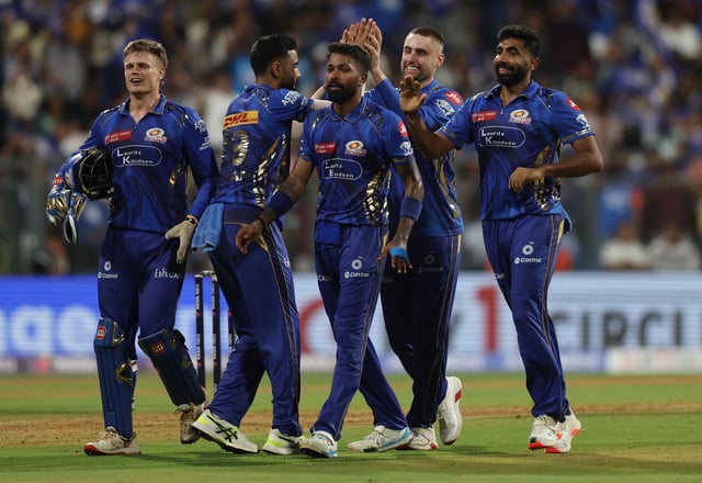 Cricket - Indian Premier League - IPL - Mumbai Indians v Sunrisers Hyderabad - Wankhede Stadium, Mumbai, India - April 17, 2025 Mumbai Indians' Will Jacks celebrates with teammates after taking the wicket of Sunrisers Hyderabad's Travis Head REUTERS/Francis Mascarenhas