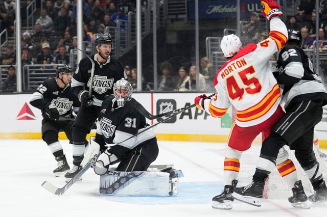 Calgary Flames center Sam Morton (45) celebrates after scoring on Kings goaltender David Rittich (31) during the third period on Thursday night at Crypto.com Arena. The Kings lost, 5-1, in their regular-season finale. (AP Photo/Mark J. Terrill)