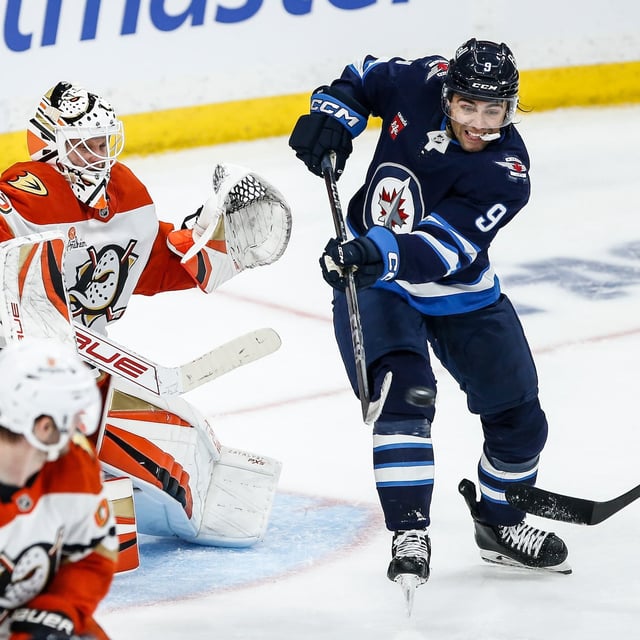 Winnipeg Jets' Alex Iafallo (9) tips the puck towards Anaheim Ducks goaltender Ville Husso (33) during third period NHL action in Winnipeg on Wednesday, April 16, 2025. THE CANADIAN PRESS/John Woods