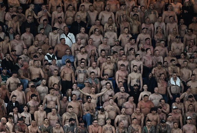 Soccer Football - Conference League - Quarter Final - Second Leg - Chelsea v Legia Warsaw - Stamford Bridge, London, Britain - April 17, 2025 Shirtless Legia Warsaw fans are pictured in the stands REUTERS/Dylan Martinez