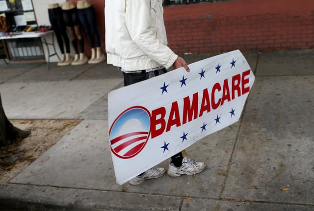 A sign directs people to an insurance company where they can sign up for the Affordable Care Act, also known as Obamacare, in Miami in 2015.