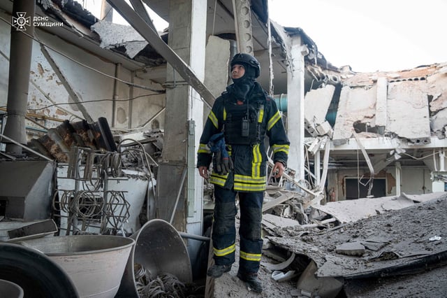 A rescuer inspects a compound of a bakery enterprise hit by a Russian drone strike, amid Russia's attack on Ukraine, in Sumy, Ukraine April 18, 2025. Press service of the State Emergency Service of Ukraine/Handout via REUTERS