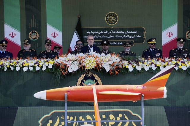 Iranian President Masoud Pezeshkian, center, reviews army&#39;s hardware as he is accompanied by armed forces commanders during the army parade commemorating National Army Day in front of the shrine of the late revolutionary founder Ayatollah Khomeini, just outside Tehran, Iran, Friday, April 18, 2025.